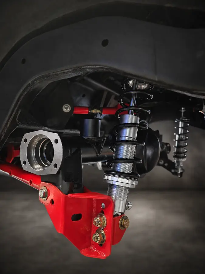 Custom suspension detail — Coilover, bracket and chassis hardware arranged around the application.