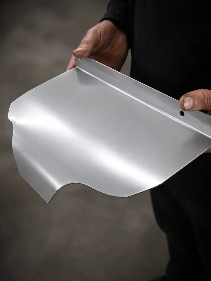 Formed aluminum panel — A one-off panel shaped for a project-specific fit.